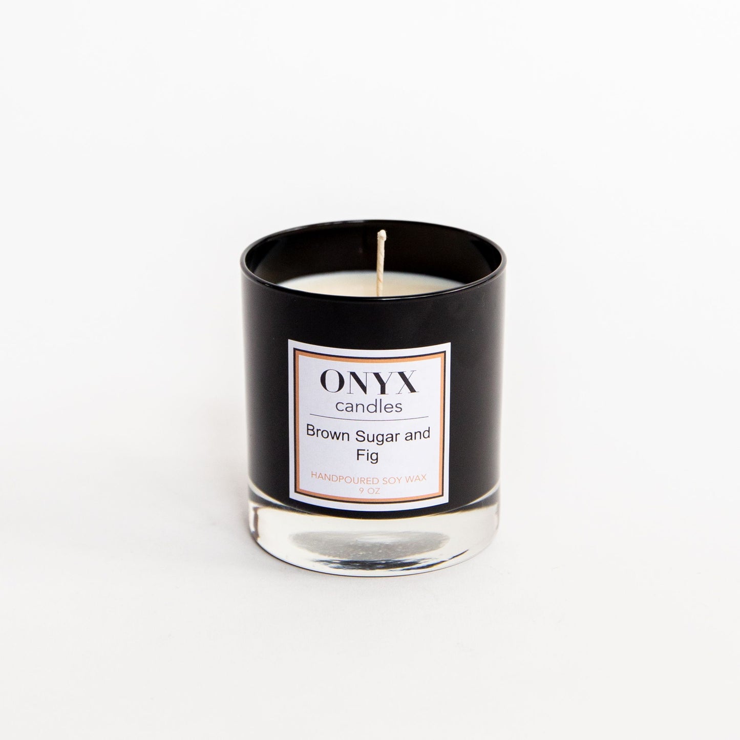 Pictured is the Brown Sugar and Fig scented candle, in a 9 oz black glass jar