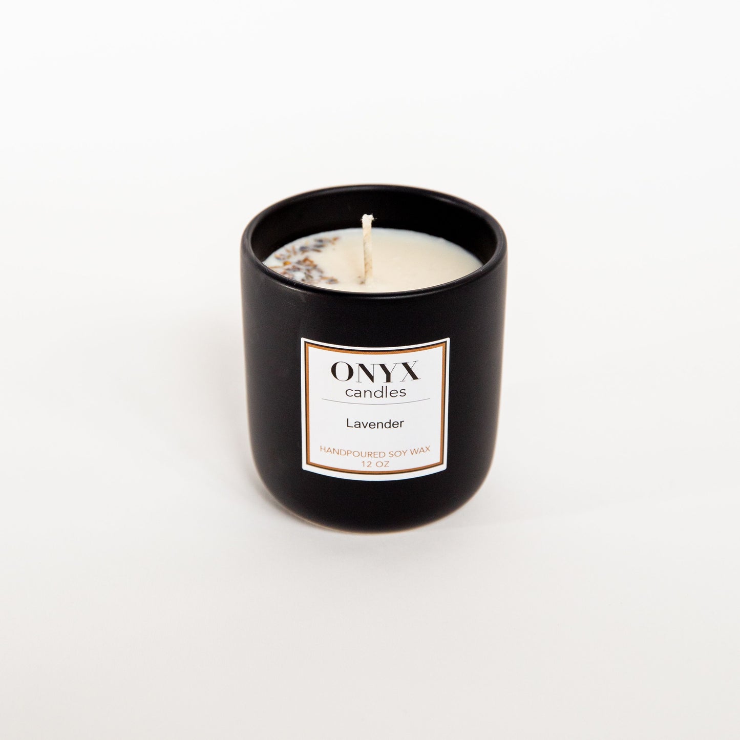 12 oz matte black ceramic jar, scented in Lavender showing details of fresh lavender melted into the wax