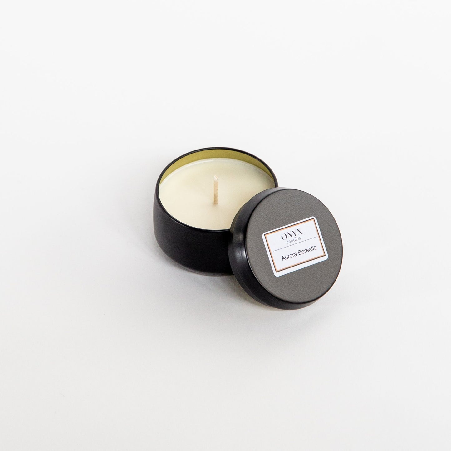 Pictured here is a 4 oz matte black tin candle, in the scent Aurora Borealis