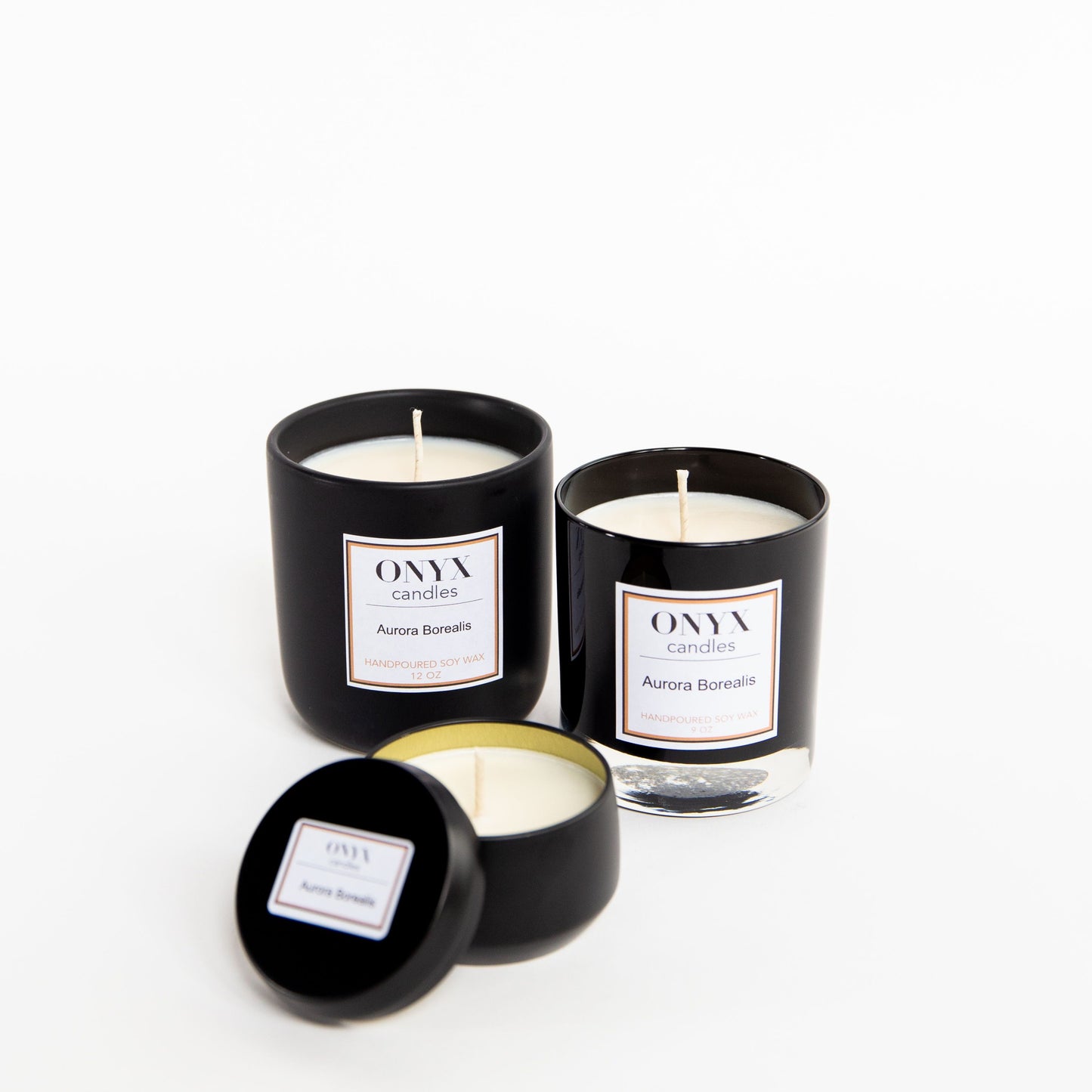 Pictured here are three size variations of Onyx Candles in the scent Aurora Borealis.