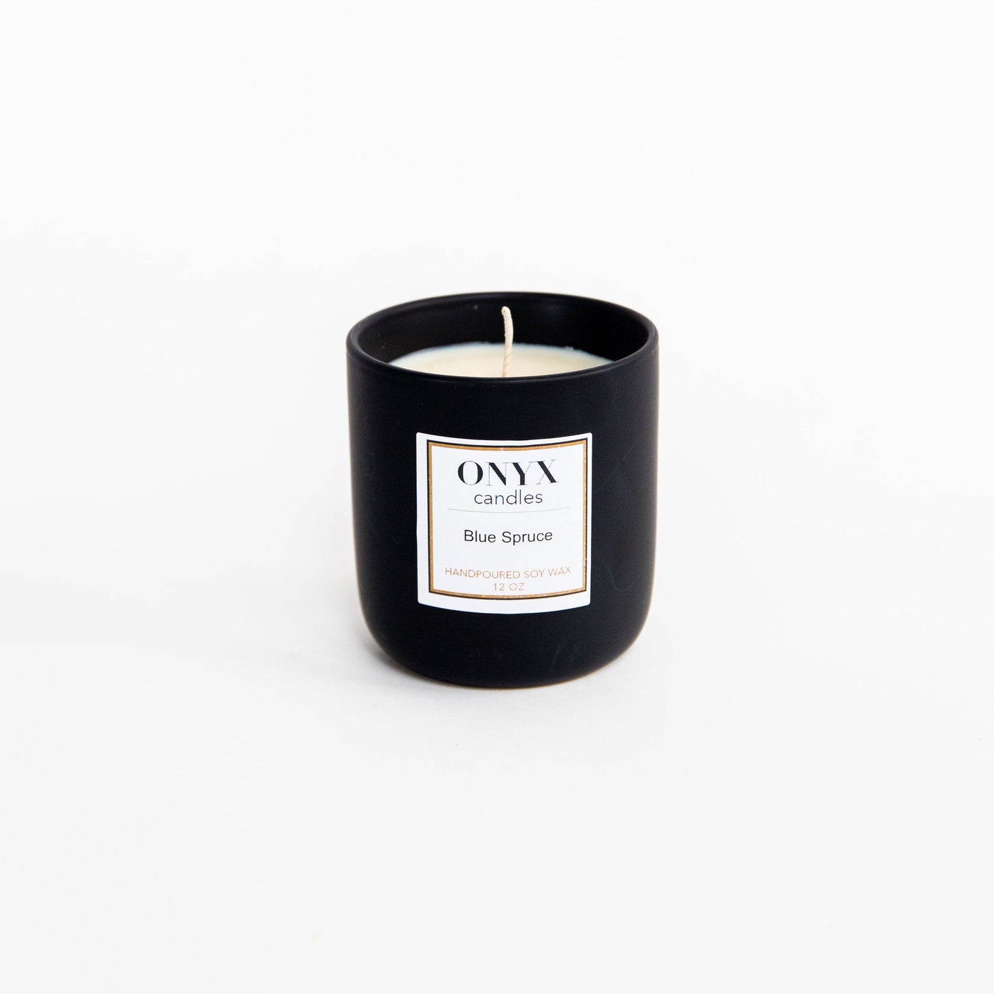 Pictured is the 12 oz matte black ceramic candle, scented Blue Spruce