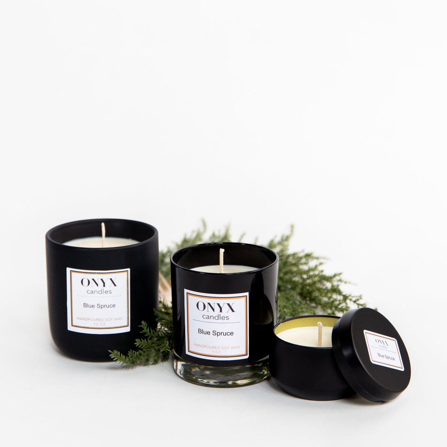 Pictured here are three size varieties for Onyx candles, scented Blue Spruce.