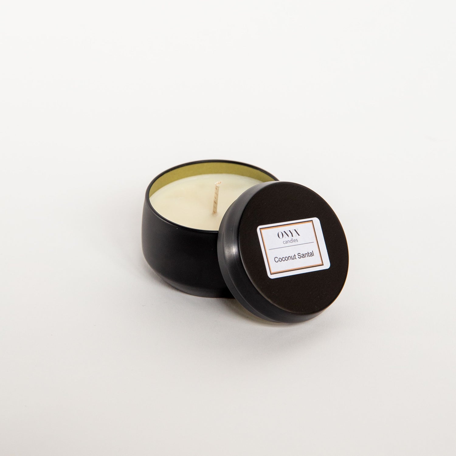 Coconut and Santal candle in a 4 oz matte black tin