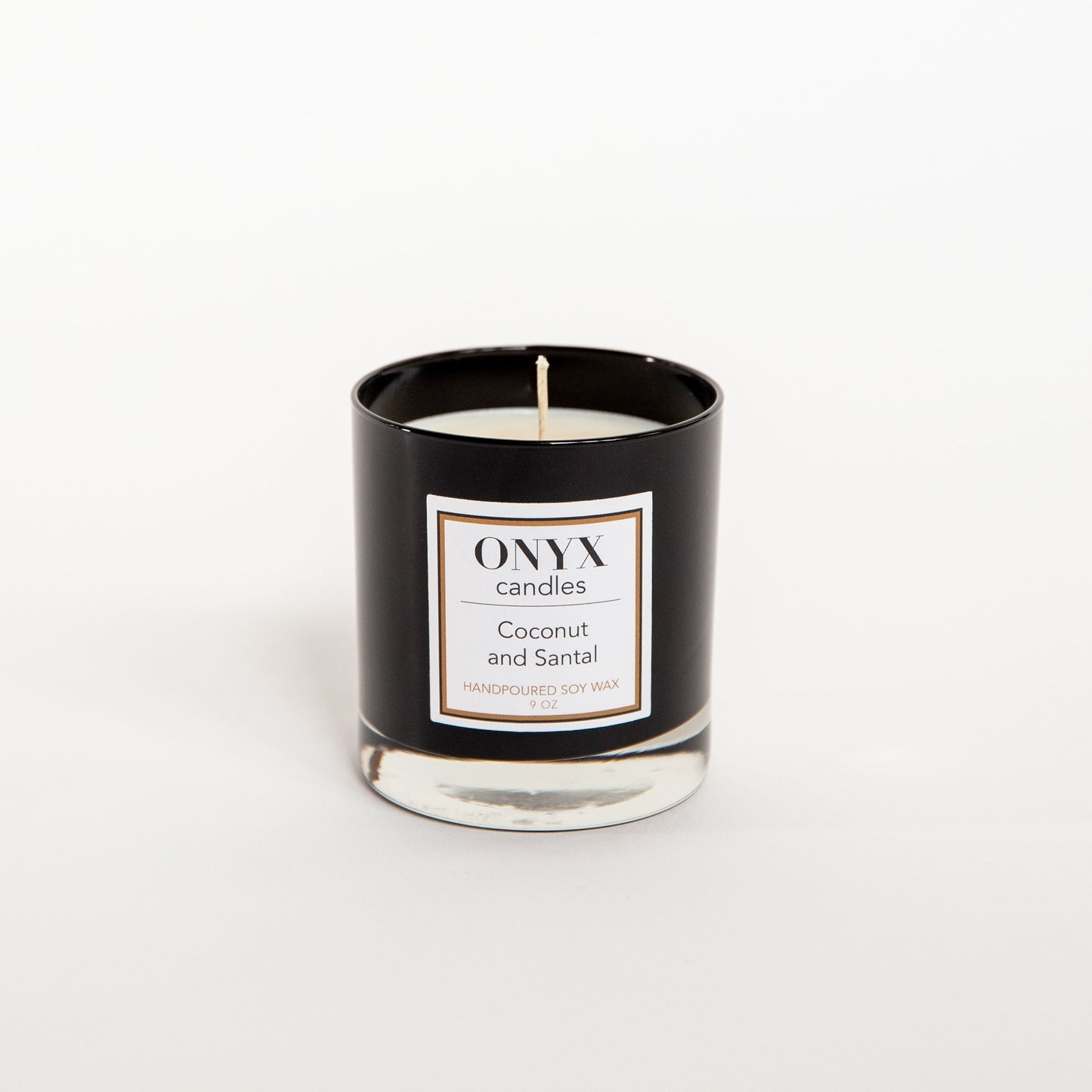 Coconut and Santal candle in a 9 oz black glass jar