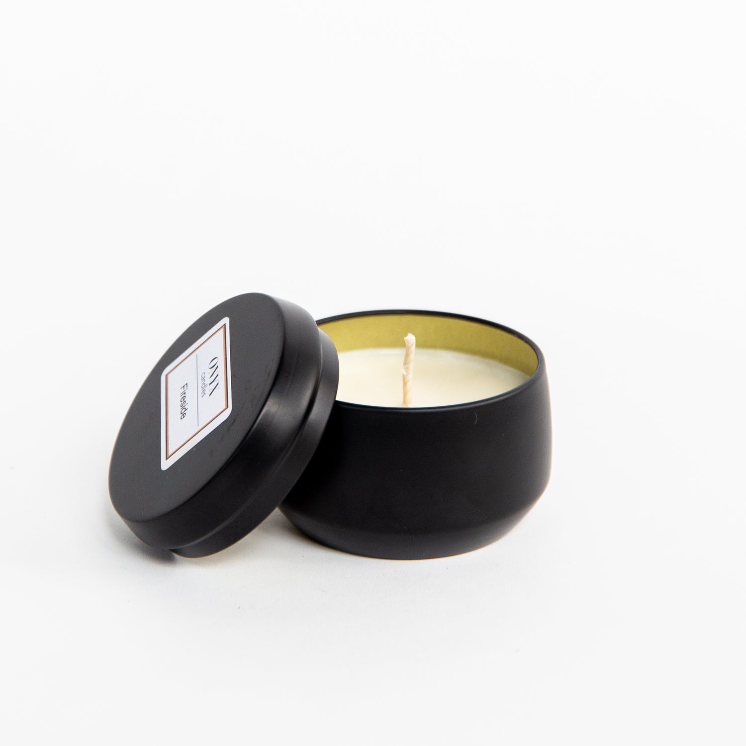 Pictured is the 4 oz matte black tin candle in the scent Fireside