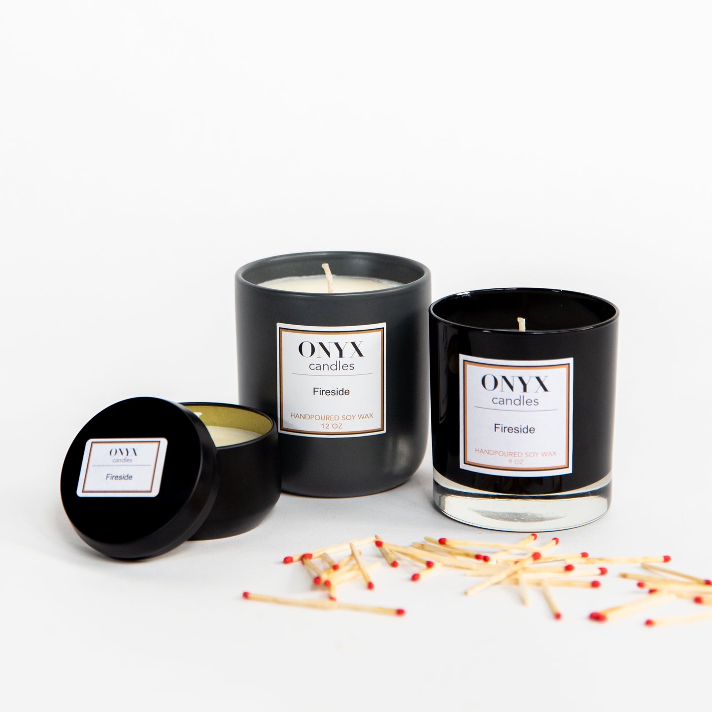 Pictured are three size options for the Fireside scented candle by Onyx Candles