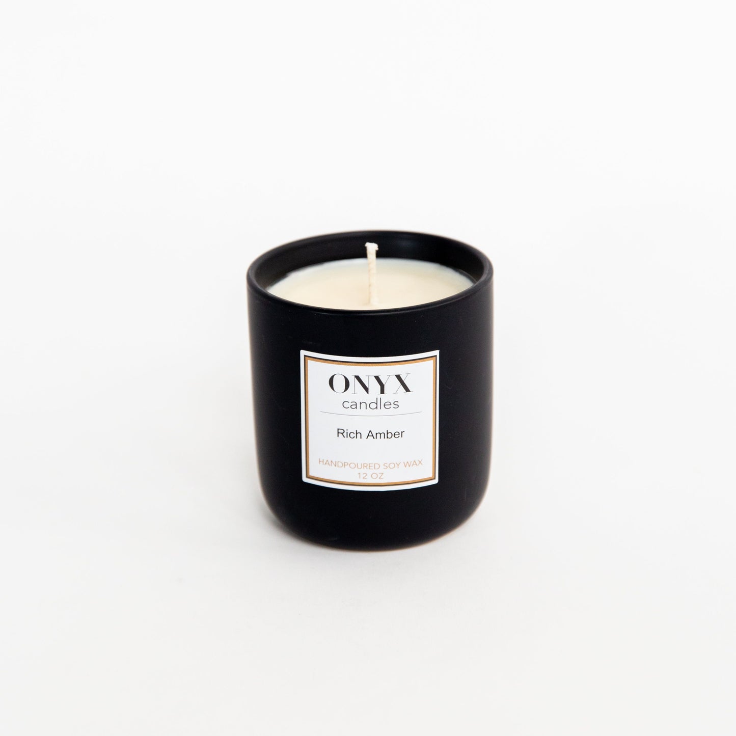 12 oz matte black ceramic candle in the scent Rich Amber