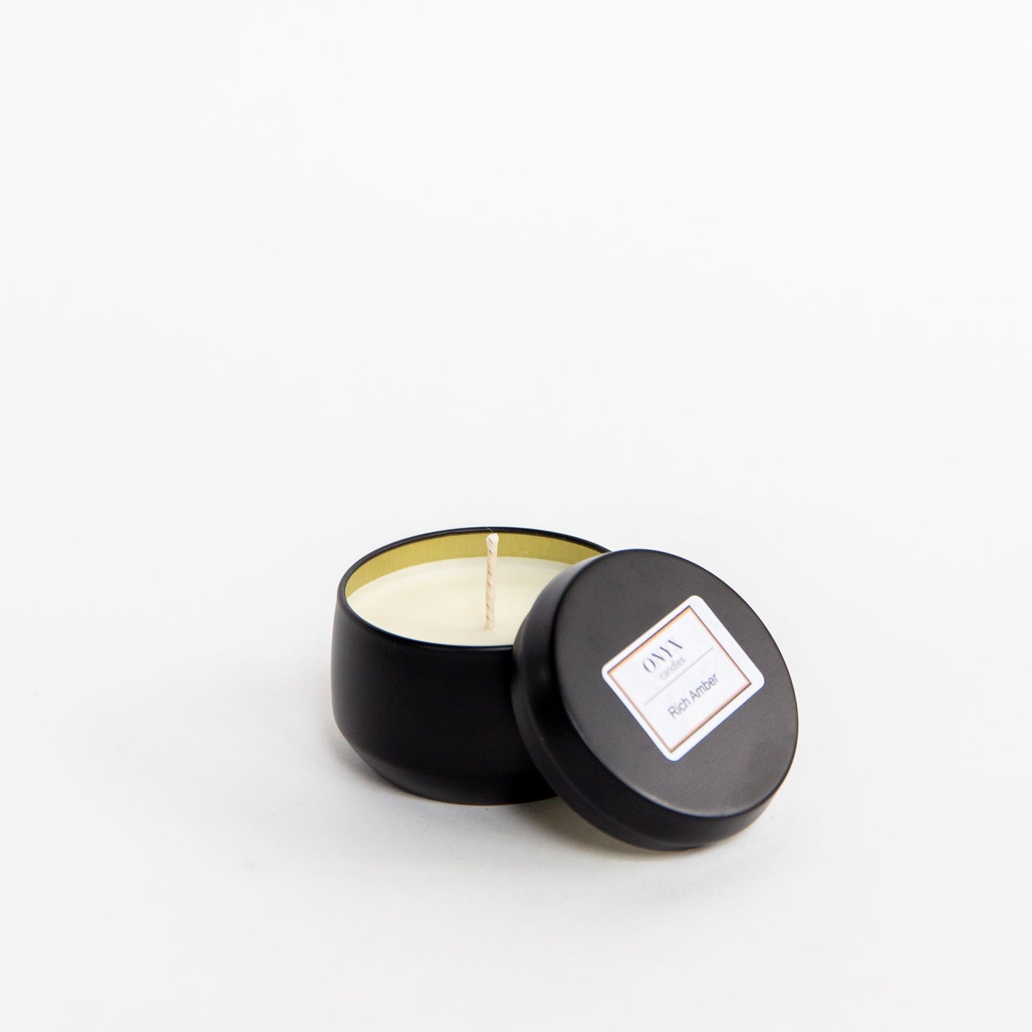 Rich Amber scented candle in a 4 oz matte black tin