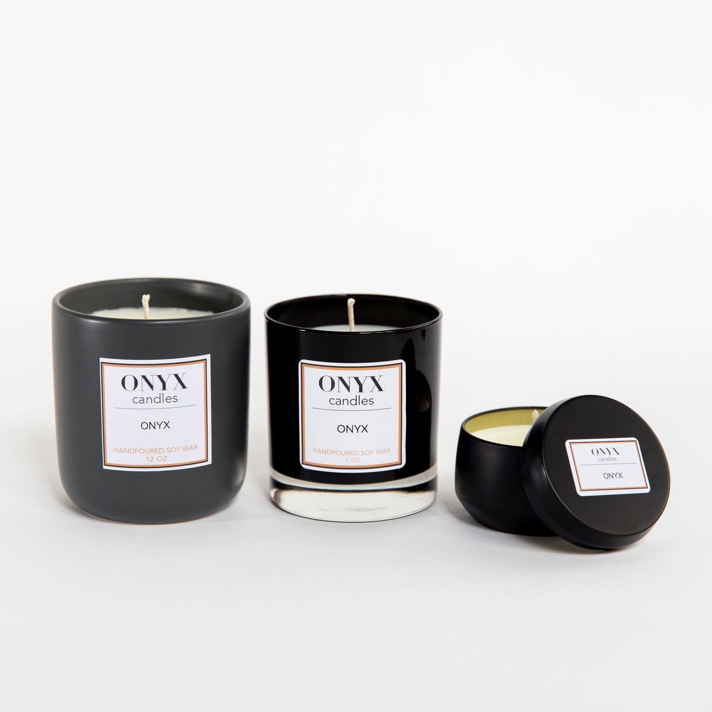 Pictured left to right, the Onyx signature scent in a 12 oz matte black ceramic jar, a 9 oz black glass jar, and a 4 oz matte black tin