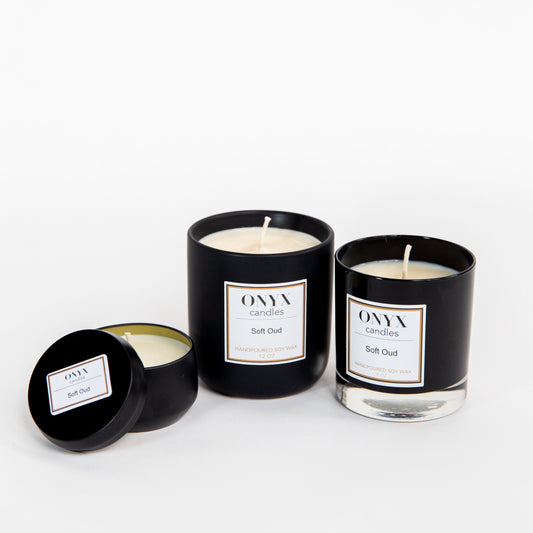 pictured left to right are the 4 oz matte black tin, 12 oz matte black ceramic jar, and the 9 oz black glass jar options for Soft Oud